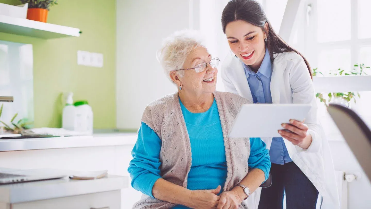 Doctor Showing Tablet To Patient