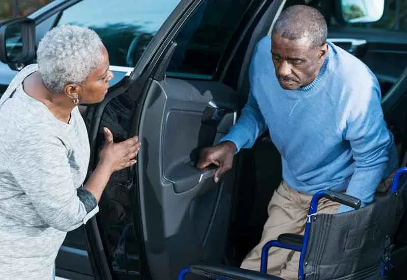  Senior Assisting Wheelchair User 
