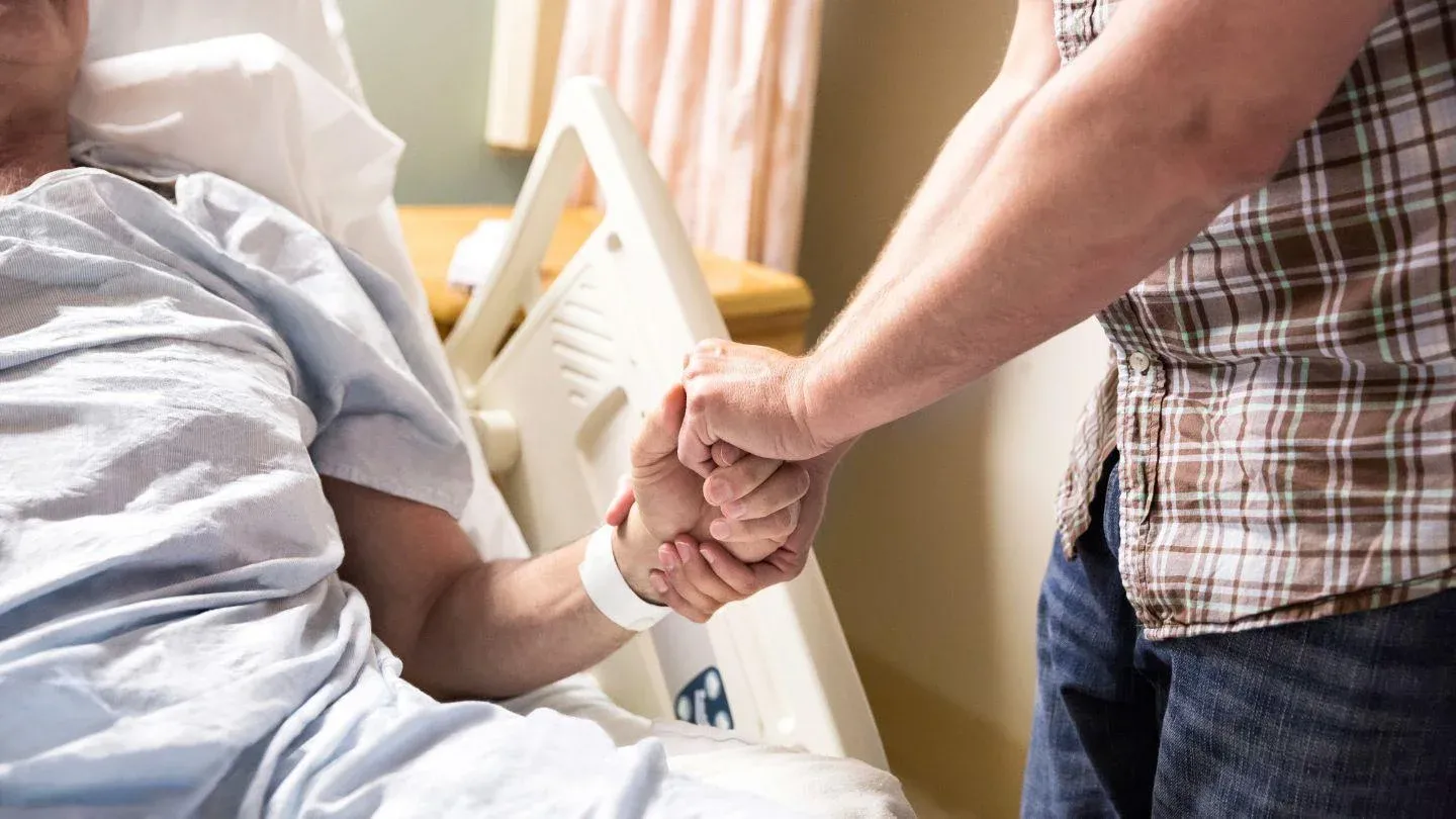 Person Holding Hand Of A Patient