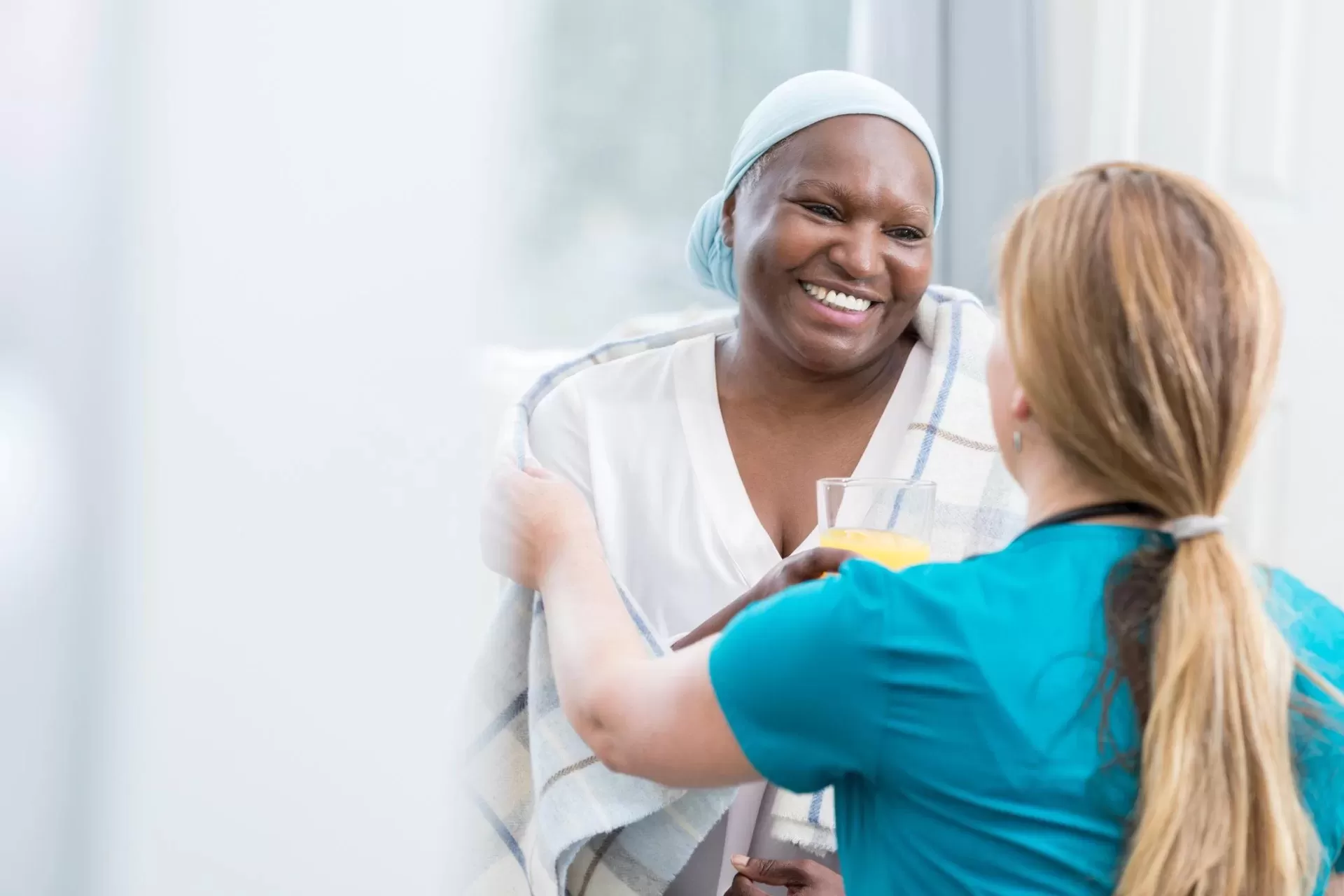 A Cancer Patient Receiving Juice From A Nurse