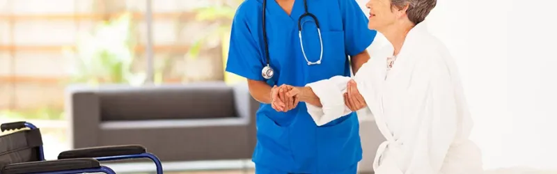 Nurse Helping Patient Out Of Bed