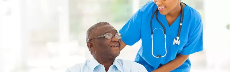 A Nurse Assisting Patient In Wheelchair