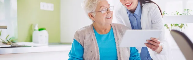 Doctor Showing Tablet To Patient