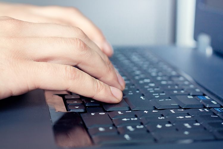 Hands Typing on a Laptop Keyboard